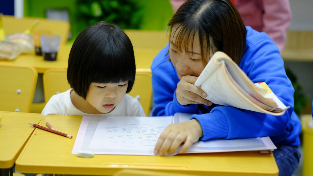 expert chinese tuition teacher teaching a child